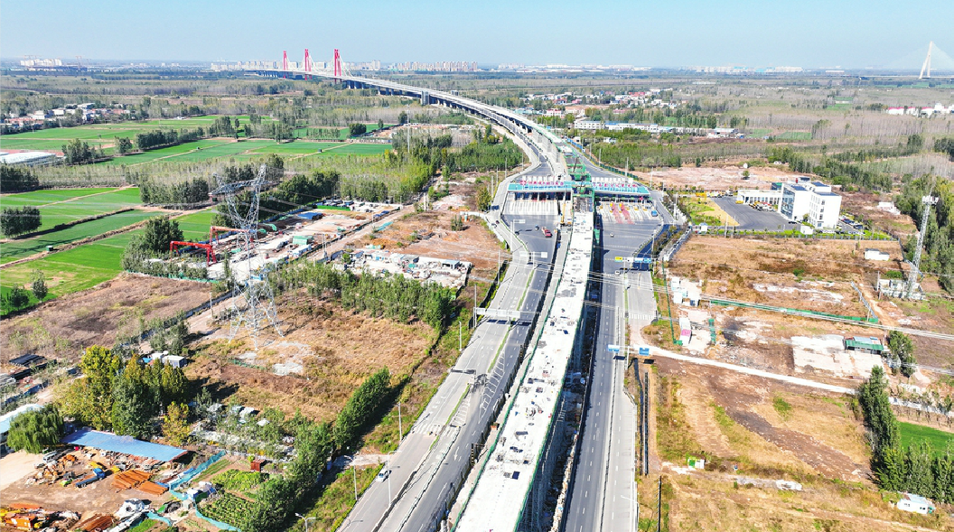 Tram Overhead Hand in Hand with Yellow River Phoenix Bridge